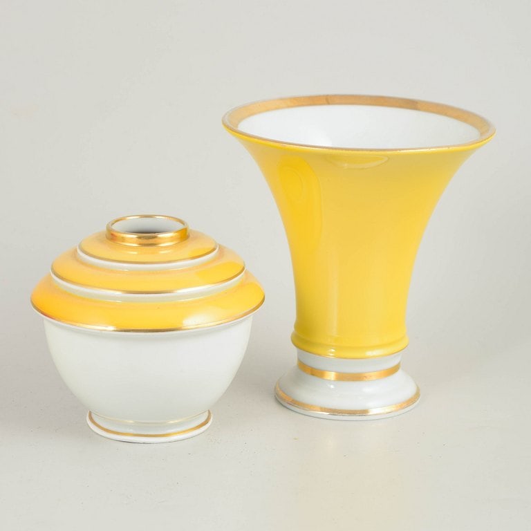Germany. Two art deco small porcelain vases in yellow and white tones with gilded details. Approx.: Two German art deco vases. Two porcelain vases with classic art deco forms and decoration in white and yellow tones with gilded details. The vases display elegant proportions and a characteristic styl