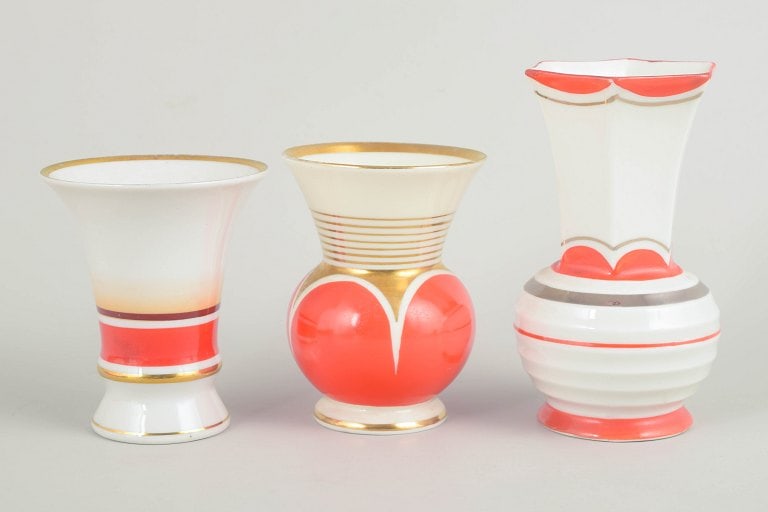 Germany. Set of three art deco small porcelain vases in red and white tones with gilded details. (1 of 4)