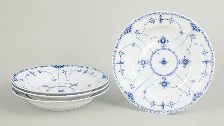 Royal Copenhagen, Denmark. Blue Fluted Half Lace set of four soup plates with underglaze cobalt blue: Royal Copenhagen Blue Fluted Half Lace set of four soup plates. Set of four hand-painted porcelain soup plates from the Blue Fluted Half Lace service with classic underglaze cobalt blue decoration and