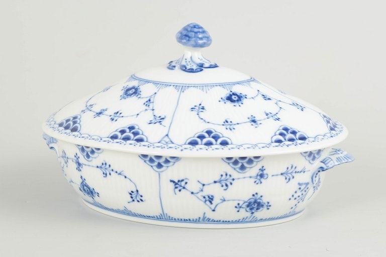 Royal Copenhagen, Denmark. Blue Fluted Half Lace oval porcelain lidded tureen with underglaze cobalt: Royal Copenhagen Blue Fluted Half Lace oval lidded tureen. Oval lidded tureen in hand-painted porcelain from the Blue Fluted Half Lace service with classic underglaze cobalt blue decoration and