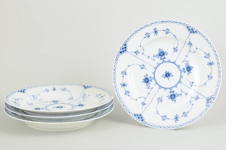 Royal Copenhagen, Denmark. Blue Fluted Half Lace set of four porcelain dinner plates with underglaze: Royal Copenhagen Blue Fluted Half Lace set of four dinner plates. Set of four hand-painted porcelain dinner plates from the Blue Fluted Half Lace service with classic underglaze cobalt blue decoration