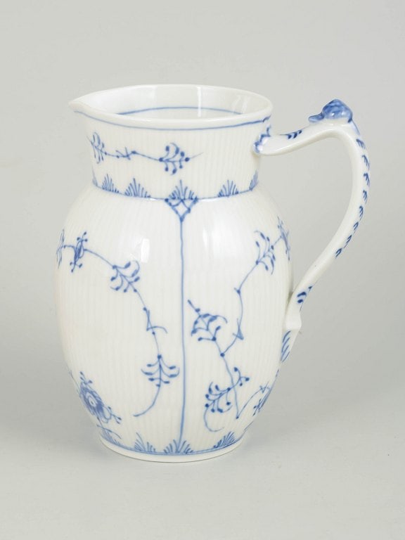 Royal Copenhagen, Denmark. Blue Fluted Plain, porcelain pitcher in cobalt underglaze. Approx. 1970s.: Royal Copenhagen Blue Fluted Plain, pitcher. Hand-painted porcelain pitcher decorated with the classic blue fluted pattern in cobalt underglaze. The form features a fluted body, shaped handle with rel