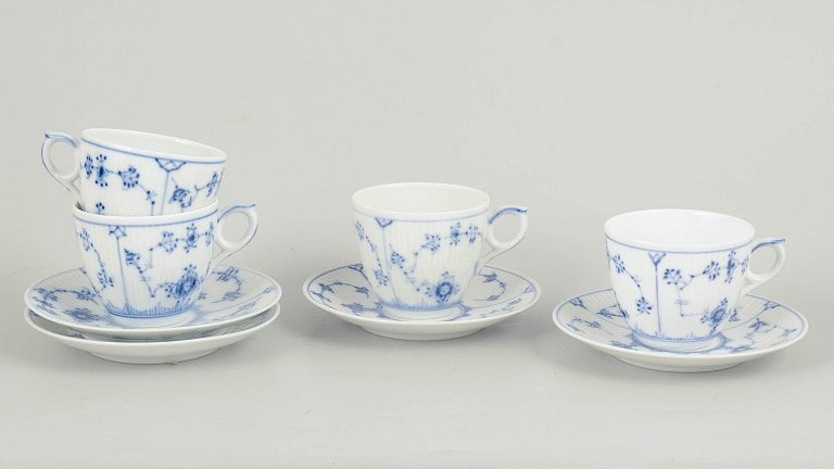 Royal Copenhagen, Denmark. Blue Fluted Plain, set of four porcelain coffee cups with saucers in: Royal Copenhagen Blue Fluted Plain, set of four coffee cups with saucers. Set of four hand-painted porcelain coffee cups with matching saucers decorated with the classic blue fluted pattern in cobalt 