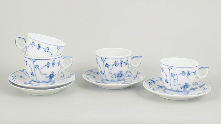 Royal Copenhagen, Denmark. Blue Fluted Plain, set of four porcelain coffee cups with saucers in: Royal Copenhagen Blue Fluted Plain, set of four coffee cups with saucers. Set of four hand-painted porcelain coffee cups with matching saucers decorated with the classic blue fluted pattern in cobalt 