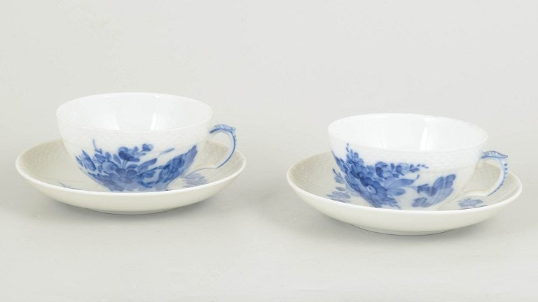 Royal Copenhagen, Denmark. Blue Flower Curved set of two porcelain teacups with matching saucers: Royal Copenhagen, Blue Flower Curved set of two teacups with matching saucers. Set of two porcelain teacups with matching saucers, decorated with hand-painted blue floral motif in relief. Model number
