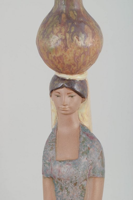 Lladró,, Spain. Porcelain figurine of woman with vessels in muted glaze tones. Approx. - 3