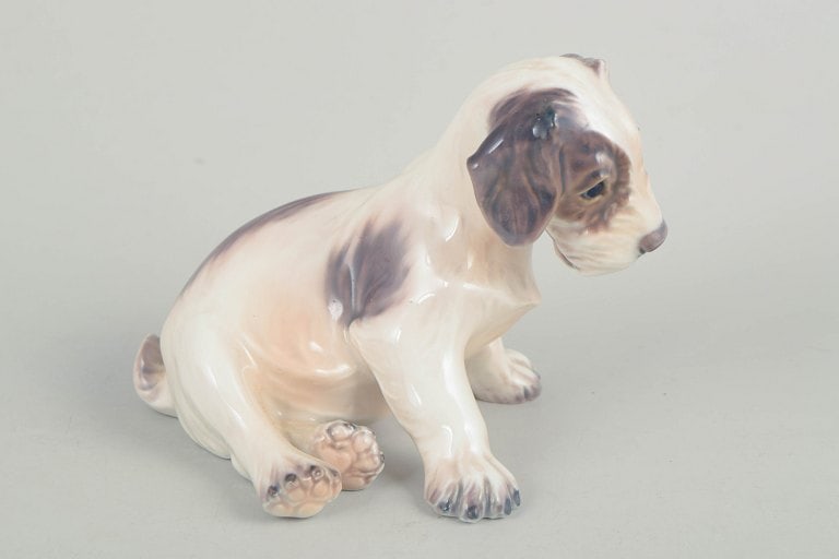 Dahl Jensen, Denmark. Porcelain dog figurine in muted tones with brown-grey accents. Approx. 1930s. - 2