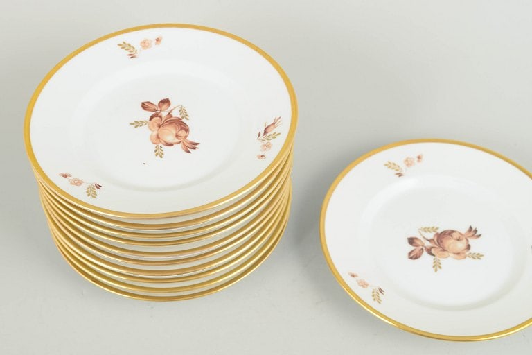 Royal Copenhagen, Denmark. Brown rose, set of eleven porcelain plates with gilded rim. Approx. - 2