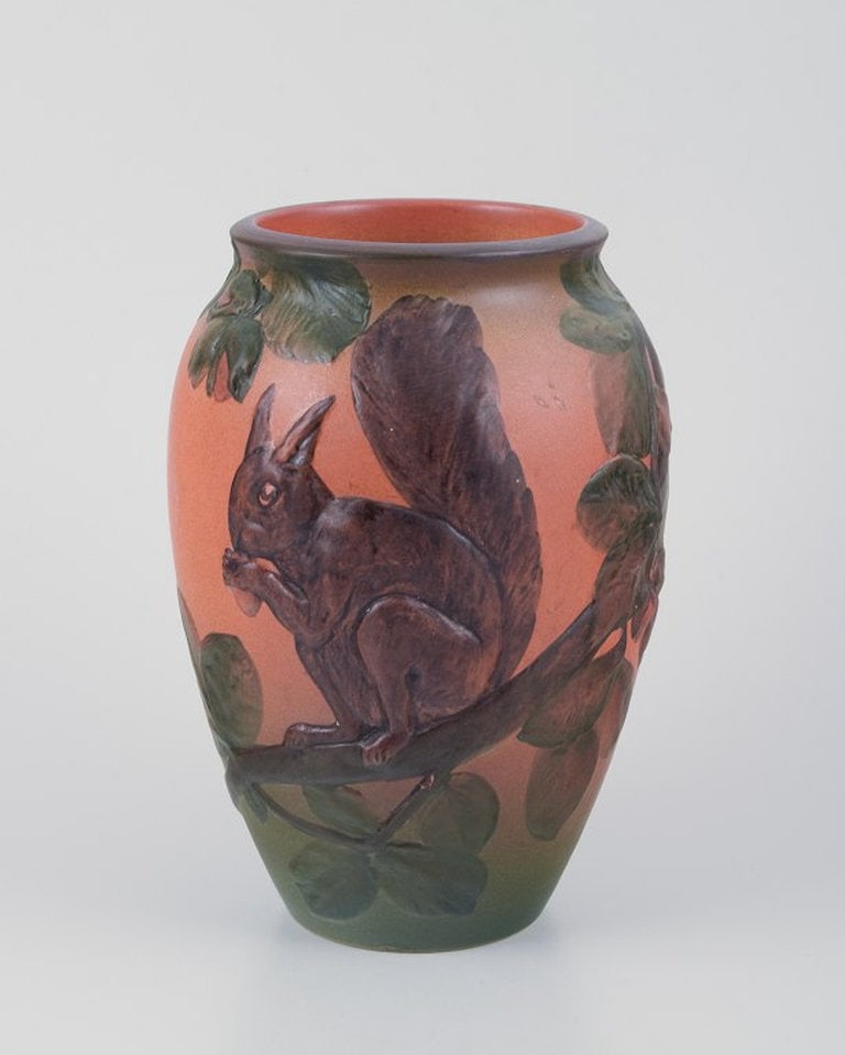 Ipsens, Denmark. Ceramic vase with squirrel. Glaze in orange and green tones. 1920s/30s.: Ipsens, Denmark, ceramic vase with squirrel, glaze in orange and green tones. Model number 795. 1920s/30s. Marked. In excellent condition, with minimal age-related wear, minimal chip on one branch.