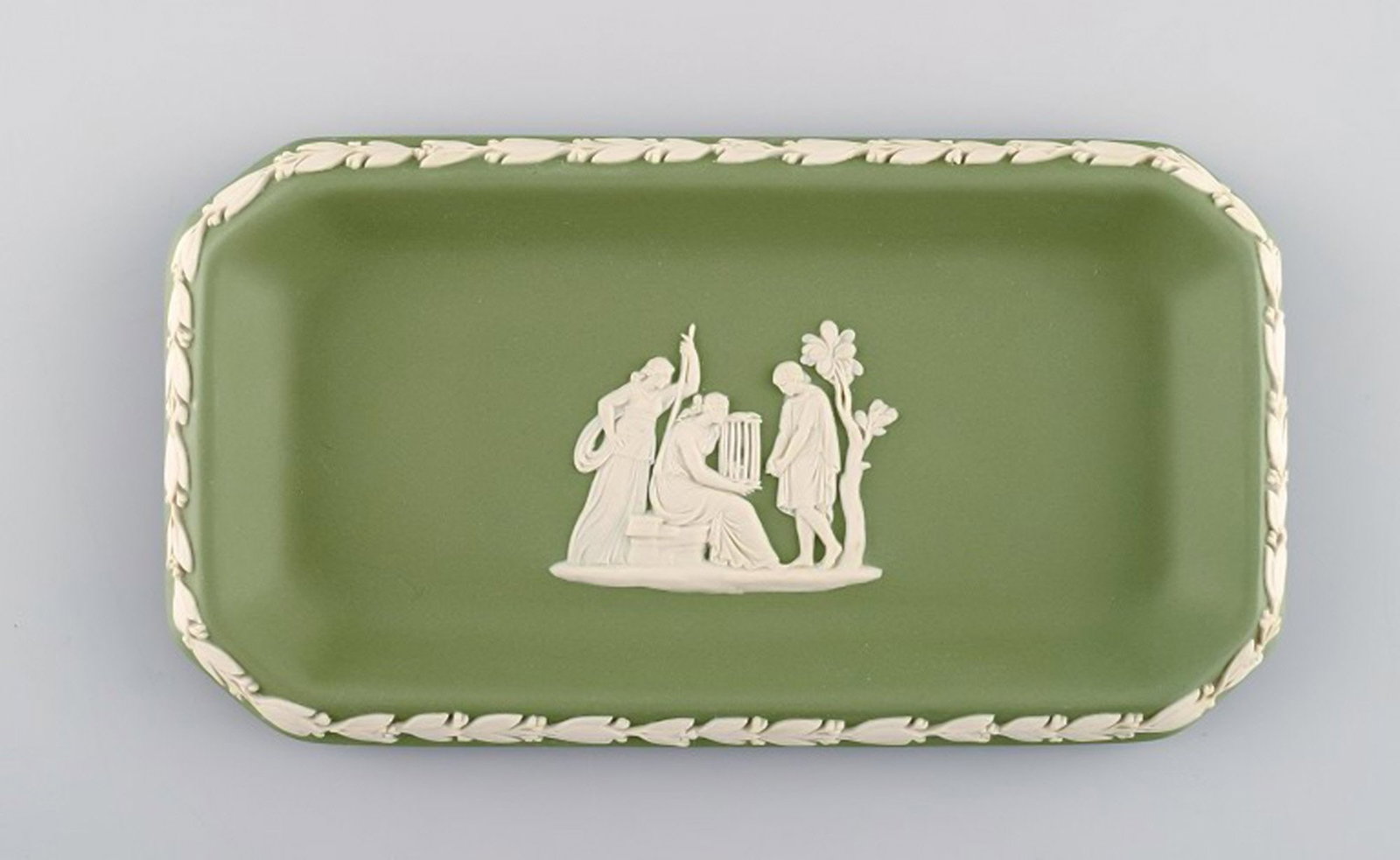 Wedgwood, England. Small square dish in green stoneware with classicist scenes in white. Approx.: Wedgwood, England. Small square dish in green stoneware with classicist scenes in white. Approx. 1930. Measures: 16 x 8.5 cm. Stamped. In very good condition.; Wedgwood, England. Small square dish in 