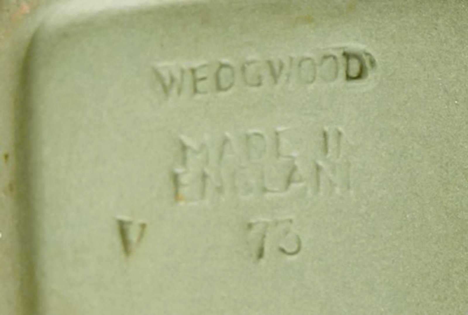 Wedgwood, England. Small square dish in green stoneware with classicist scenes in white. Approx. - 4