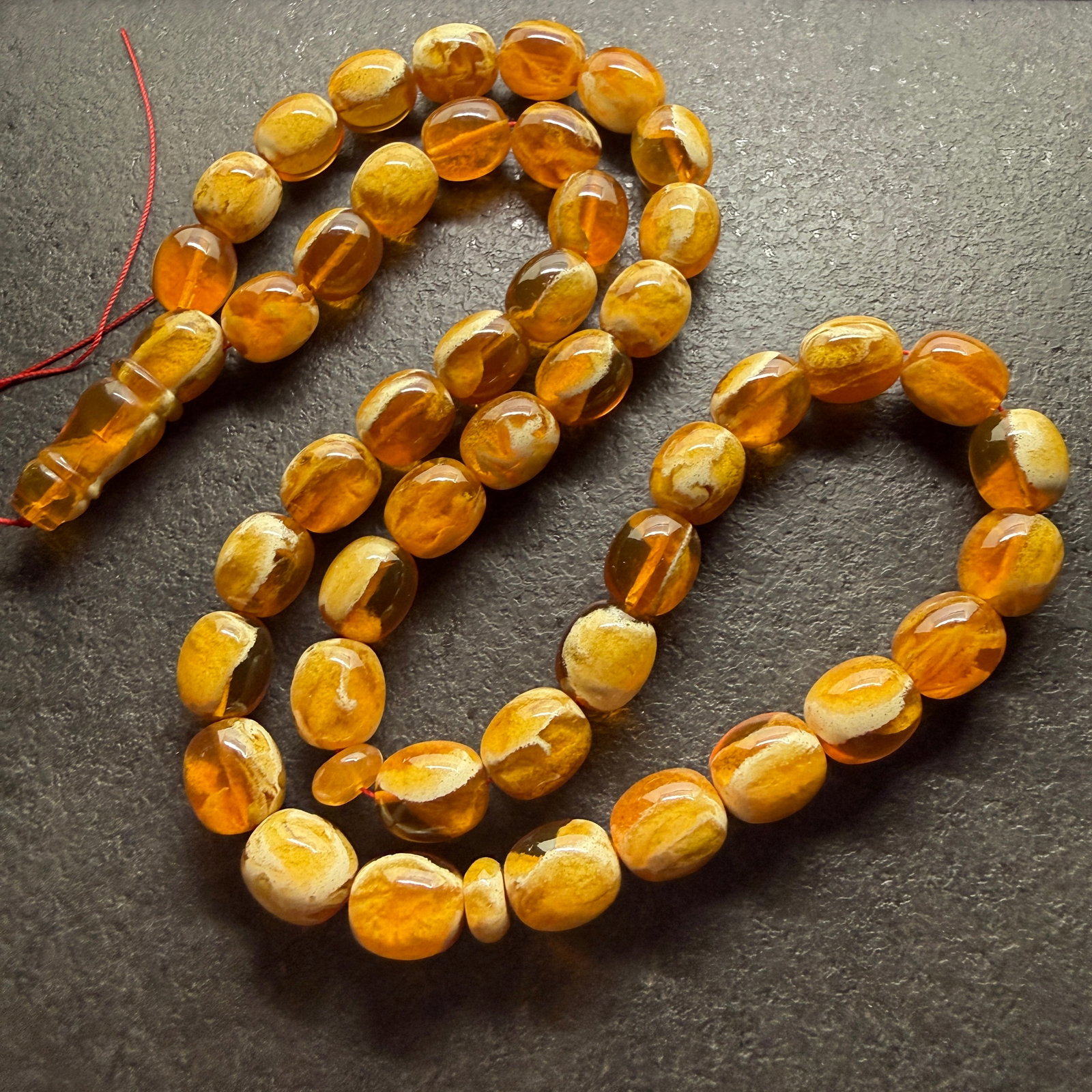 Alluring Amber Tesbih made from Round Amber beads with White Pattern: Title:Alluring Amber Tesbih made from Round Amber beads with White Pattern Metal:None Gemstone:Reconstituted Amber Weight:93.07 g Size:16x14mm Made of:(Reconstituted Amber or Whole