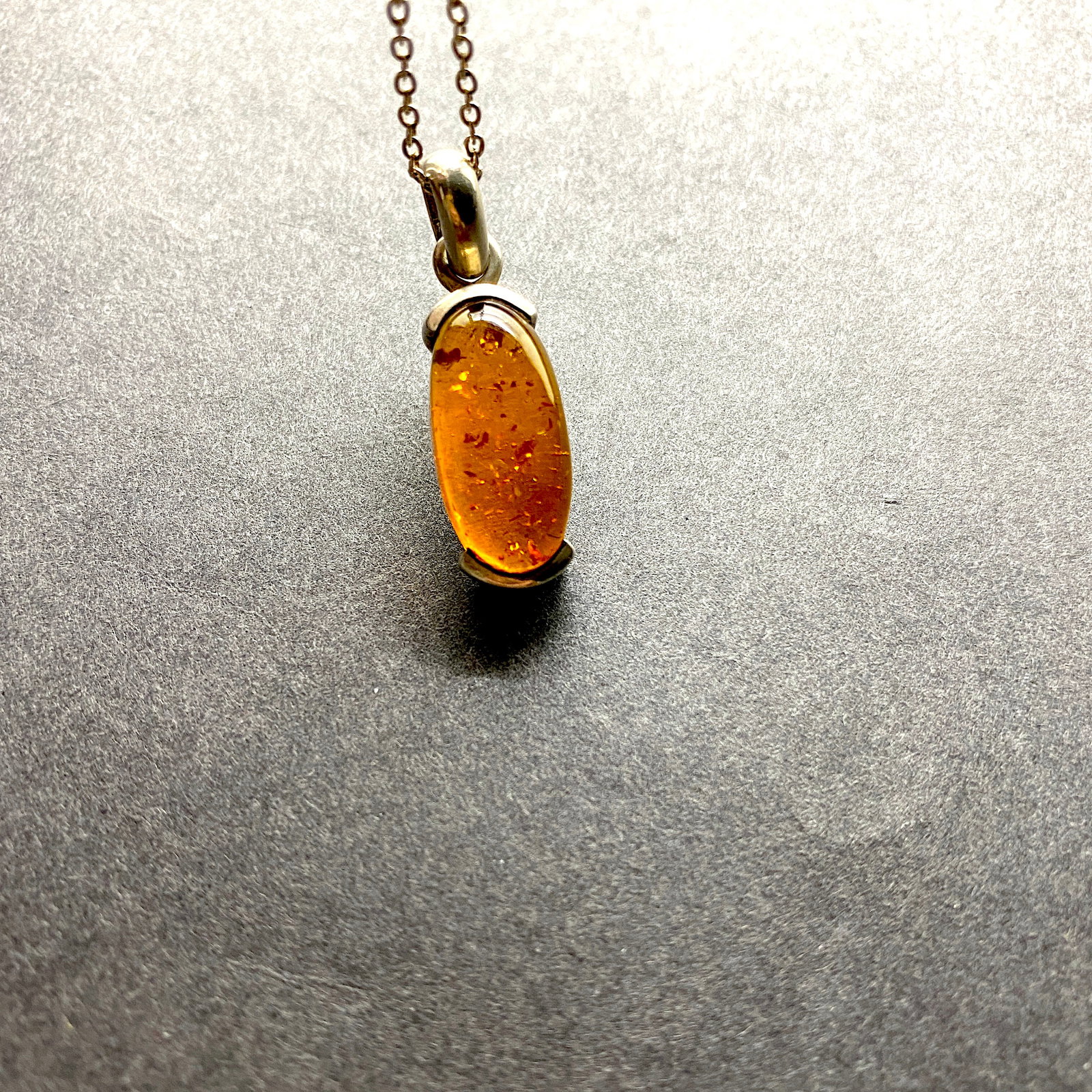 Remarkable Amber Pendant with chain, shaped like an Ornament: Title:Remarkable Amber Pendant with chain, shaped like an Ornament Metal:Sterling Silver Gemstone:Amber Weight:7.2 g Size:Size: 26.0 x 10.5 x 9.0 mm Size: 1.024 x 0.413 x 0.354 inches Made