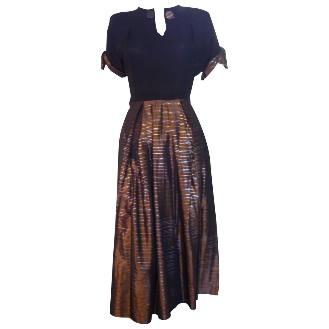 1940s Vintage Flora Originals Women's Black Crepe Dress with Accents: Title:1940s Vintage Flora Originals Women's Black Crepe Dress with Accents Description:Black crepe top and bronze and gold metallic rayon or acetate make up this lovely dress. The metallic pattern is 