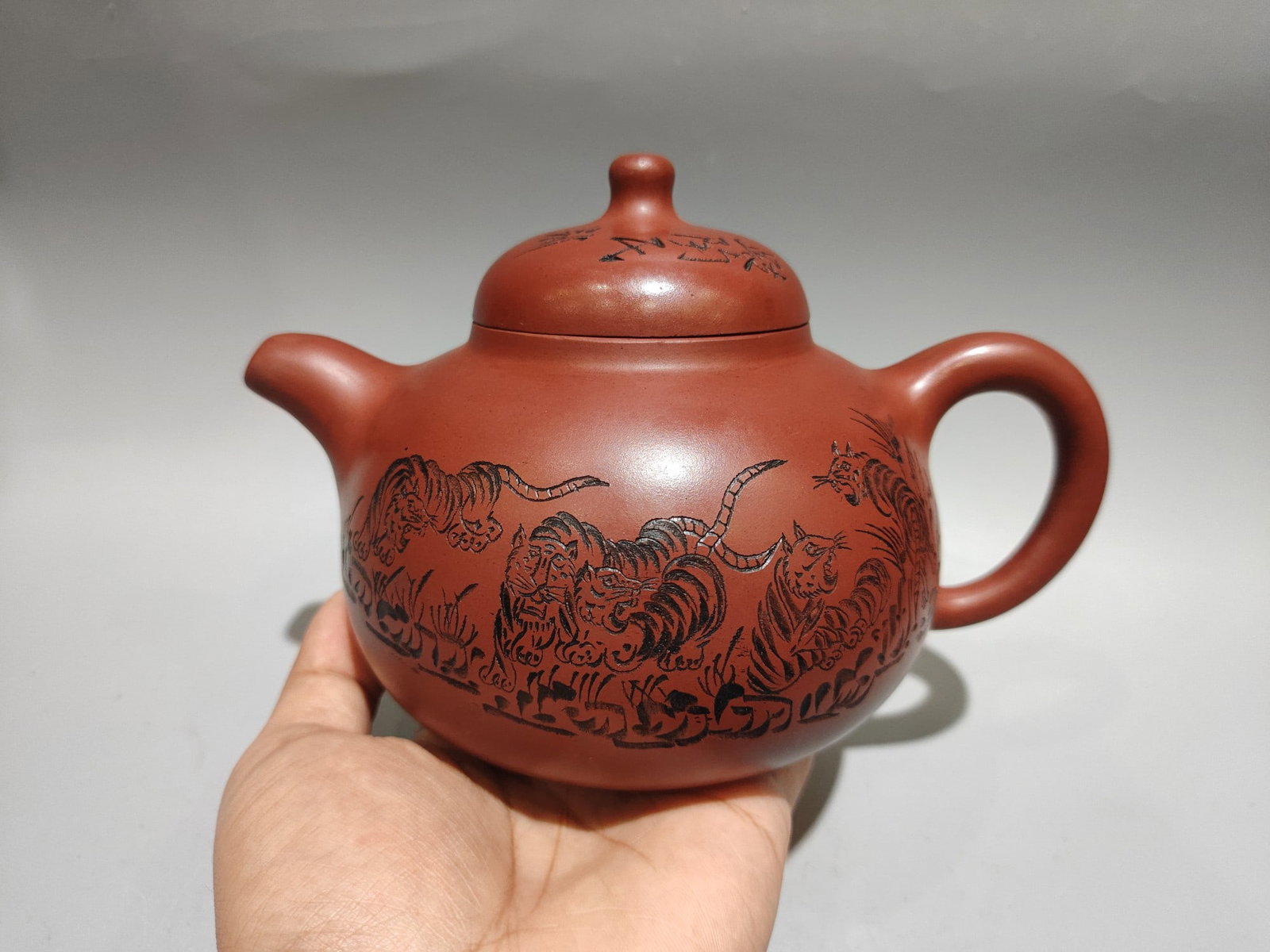 Yixing Zisha Clay Carved Eight Tiger Teapot: Title: Yixing Zisha Clay Carved Eight Tiger Teapot Origin: Chinese Materials: Yixing Zisha Dimensions: 190x120(mm) 7.48x4.72(inches) Reserve: $280.00 Shipping: Domestic: Shipping rates are determined 