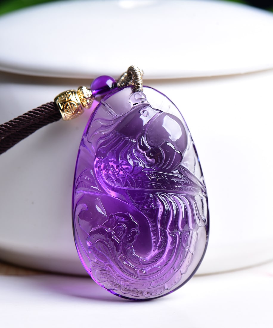 Purple Crystal Carved Phoenix Pendant: Title: Purple Crystal Carved Phoenix Pendant Origin: Chinese Date/Period: After2026 Materials: Crystal Dimensions: 43.3x27.6x12.3(mm) 1.70x1.09x0.48(inches) Weight 0.05 lbs/23.2g Reserve: $499.00 Ship