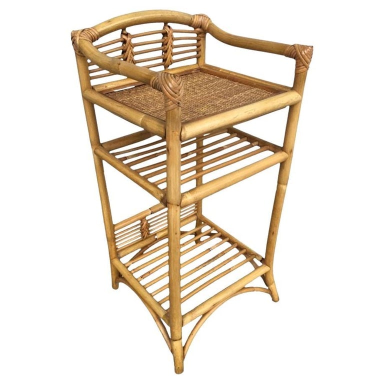 Restored Mid-century Rattan & Wicker Three-Tier Book/Magazine Holder: This beautifully restored Paul Frankl Style three-level rattan book self with a hand-woven rice mat shelf on top and decorative stick rattan backplate along the top and bottom to display a decorative 