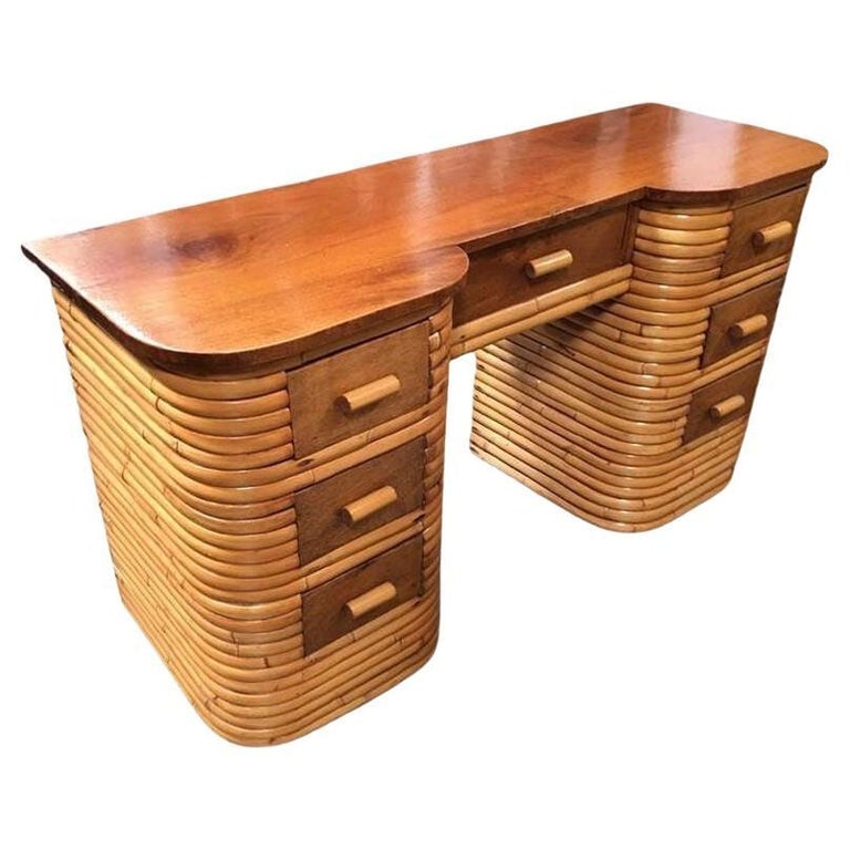 Restored Art Deco Stacked Rattan Secretary Desk w/ Mahogany Top: This beautifully restored Paul Frankl-inspired stacked rattan secretary desk with a mahogany top, center drawer with two sets of drawers on each side of the desk all encased in stacked Rattan Base. Th