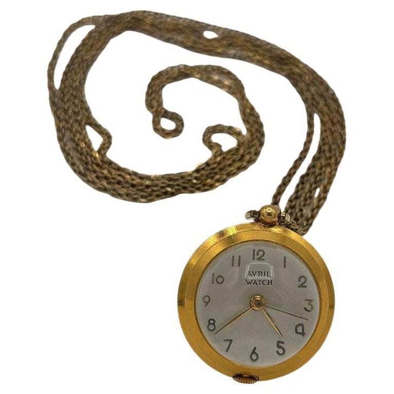 French Gold Bubble Pendant Watch w/ Skeleton View by Avril w/ 14K Gold Chain: This exquisite gold Avril Bubble Pendant Watch features a clear glass dome that showcases its intricate inner workings. The Saturn-like rings around the face enhance its celestial aesthetic. Designed