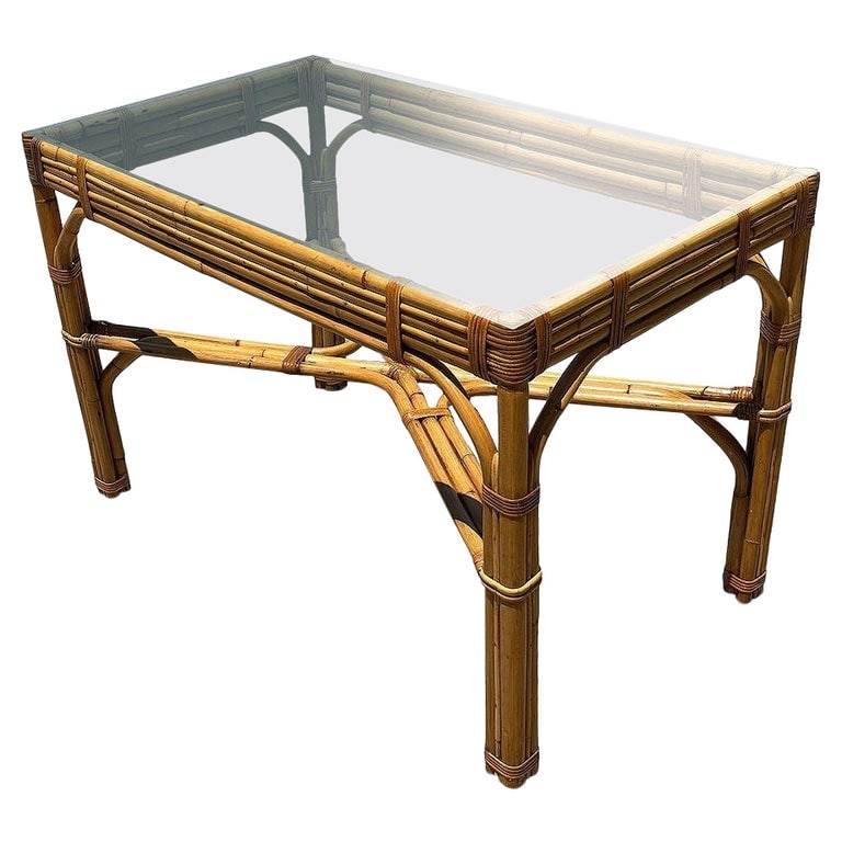 Restored Glass Top "X" base 3-strand Rattan Dining Table: This beautifully restored Paul Frankl-inspired Mid-century Stacked Rattan Glass Top Dining Table is a striking blend of vintage design and modern refinement. Featuring a sturdy 3-strand base with