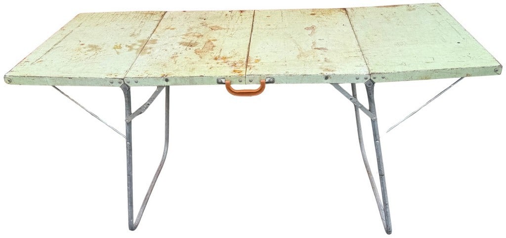 Vintage Green Painted Folding Card Table: This vintage folding card table features a wooden top painted in a distressed light green finish, showing significant wear, scratches, and discoloration consistent with age and use. The top is compose