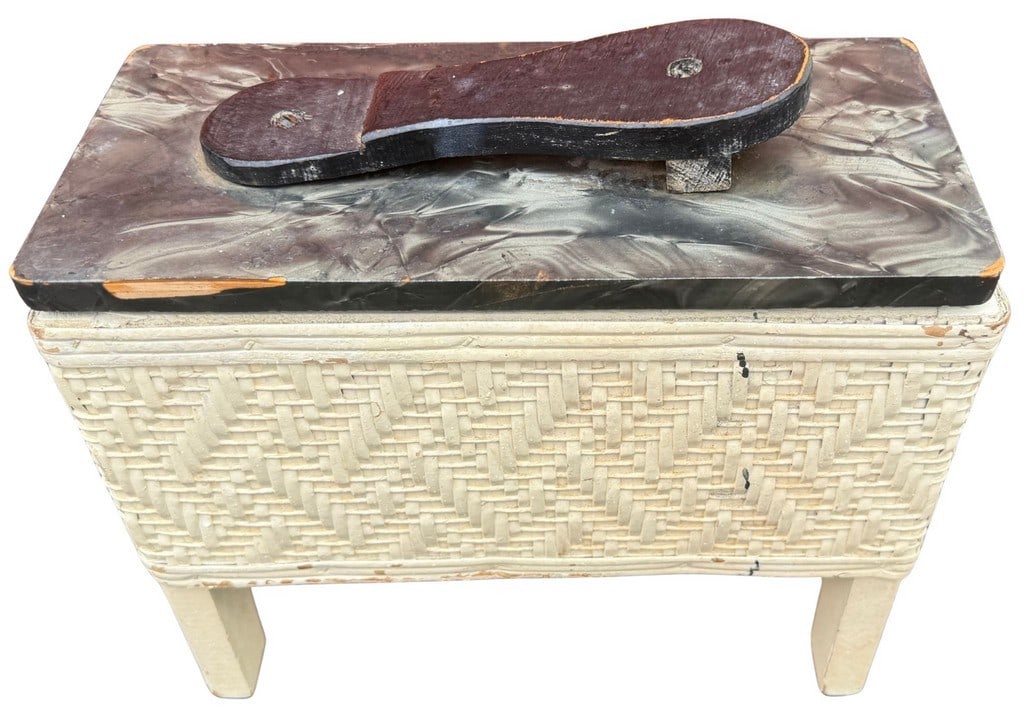 Vintage Mid-Century Woven Rattan Shoe Shine Box with Foot Rest: This vintage mid-century shoe shine box features a charming woven rattan body in an off-white finish, complemented by a mottled gray and black lid. The lid is equipped with a black painted wooden