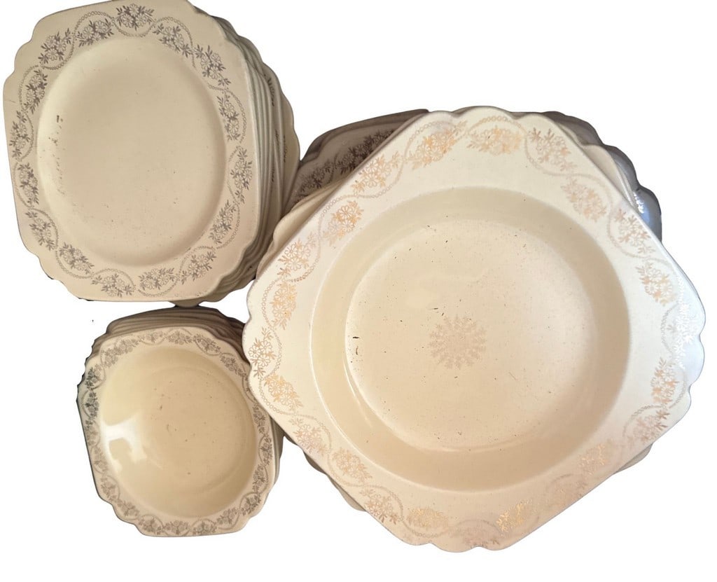 Vintage Scalloped Edge Dinnerware Set: A charming full set of square plates with scalloped edges and a delicate floral pattern. The cream-colored ceramic plates are adorned with a repeating gilt floral and vine motif around the rim, with