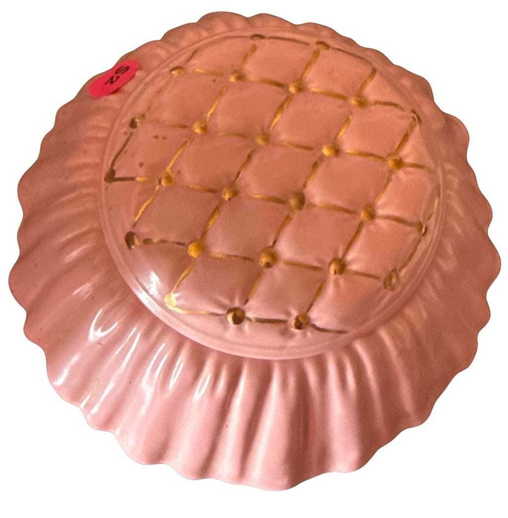 Avon Pink Scalloped Covered Powder Dish: This charming vintage Avon powder dish is crafted from pink plastic with a scalloped edge. The lid features a molded, quilted design with gold accents, replicating the tufted look of a vintage