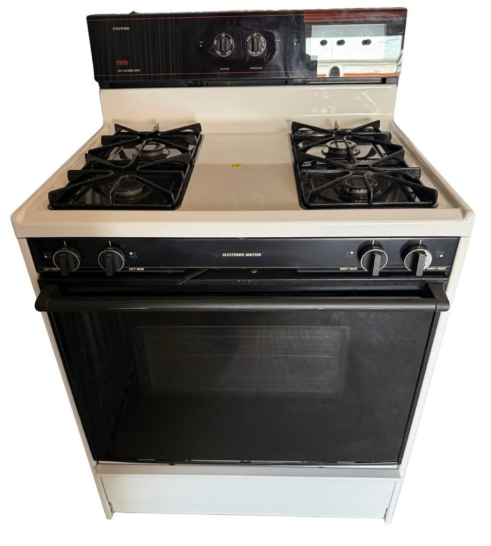 Tappan Self-Cleaning Gas Range: This Tappan self-cleaning gas range features a white enamel finish with a black control panel and oven door. It includes four gas burners with grates and an oven with two racks. The electronic