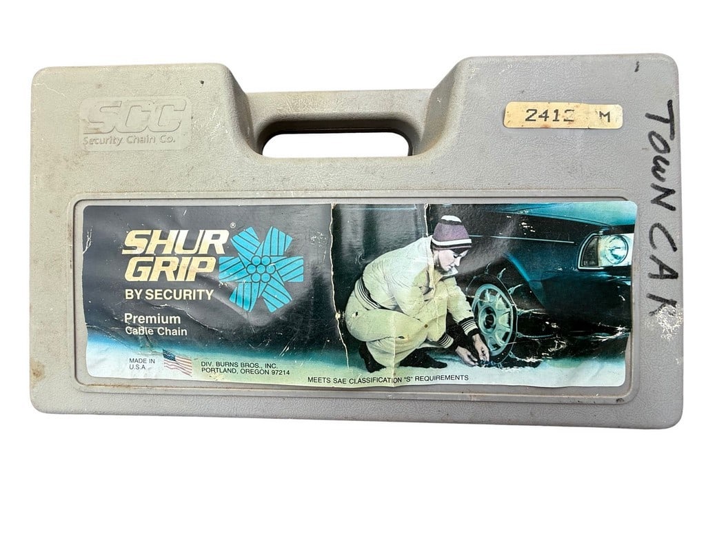 Shur Grip by Security Premium Cable Chain in Original Case: This lot features a set of Shur Grip by Security premium cable chains, presented in their original gray plastic carrying case. The case has a label featuring an illustration of a person installing