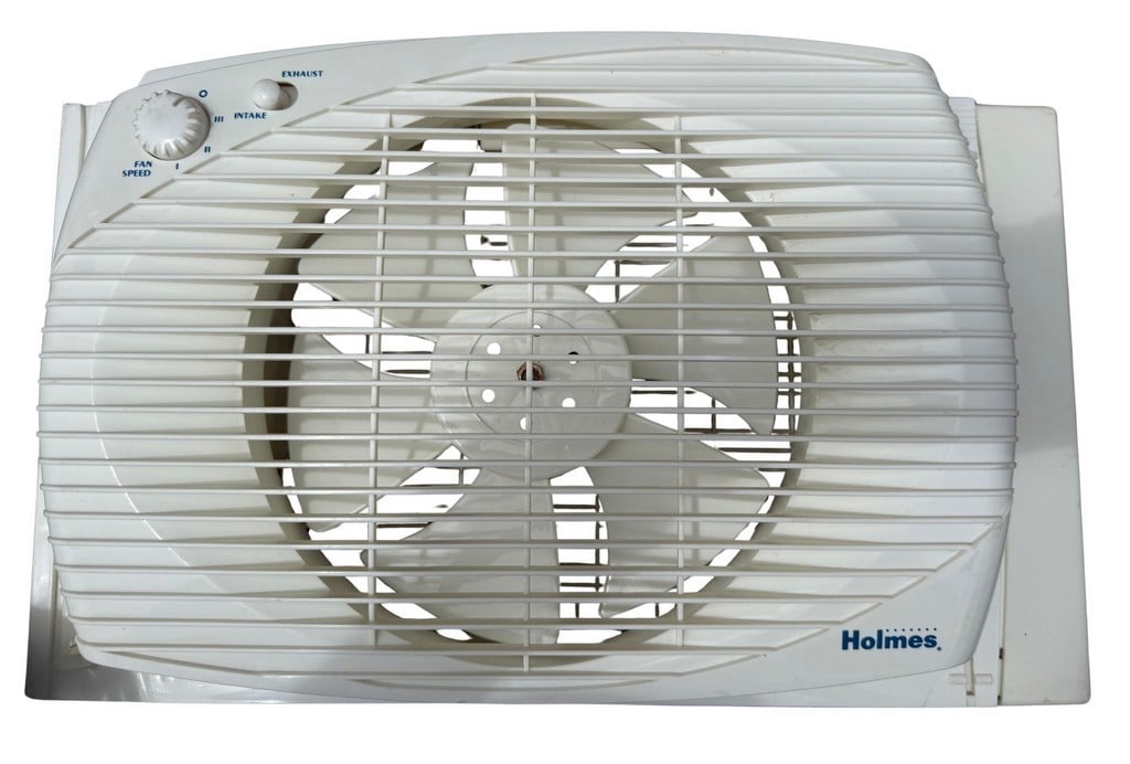 Holmes Window Fan: This vintage Holmes window fan (model number not visible) features a white plastic casing with three fan speeds and the ability to switch between intake and exhaust functions. The fan includes an