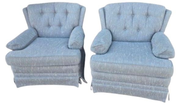 Pair of Mid-20th Century Tufted Armchairs: A handsome pair of mid-20th century armchairs, upholstered in a light blue textured fabric with classic tufting on the backrests. Each chair features rolled arms and a skirted base, emblematic of the