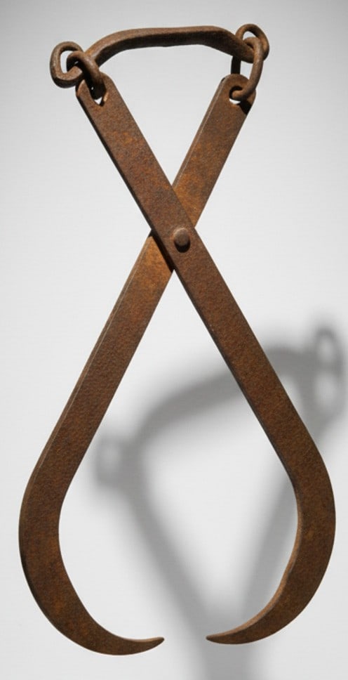 Antique Hand-Forged Ice Tongs: These antique hand-forged hay bale or ice tongs, likely from the late 19th or early 20th century, showcases rustic charm. Crafted from robust iron, the tongs feature large, curved hooks designed for g