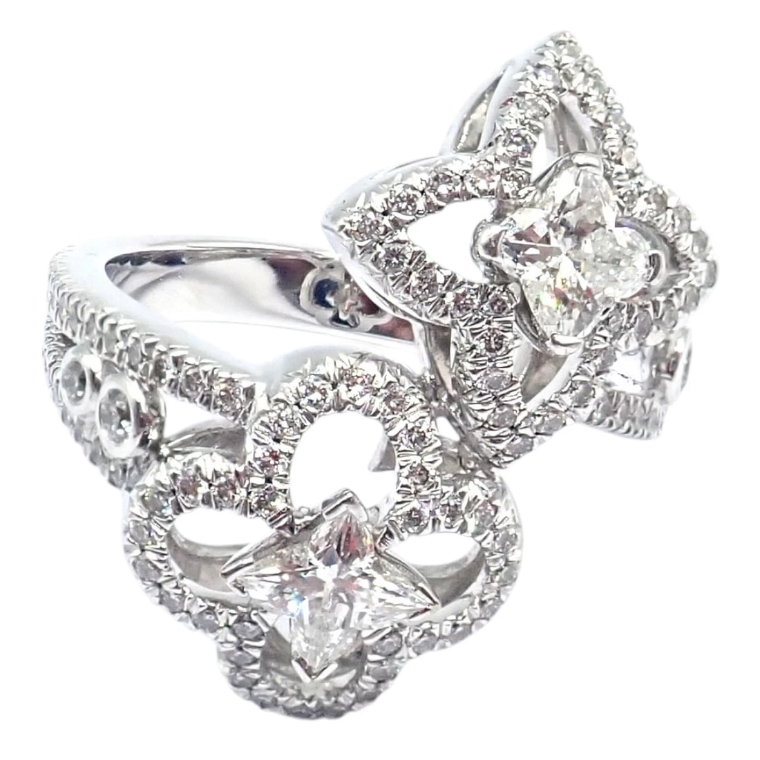 Authentic Louis Vuitton LV 18k White Gold Signature Diamond Fusion Blossom Ring: Crafted in 18k white gold, this Louis Vuitton Signature Blossom ring showcases the iconic Monogram flower motif, adorned with brilliant pavé diamonds. Two central star-shaped diamonds radiate