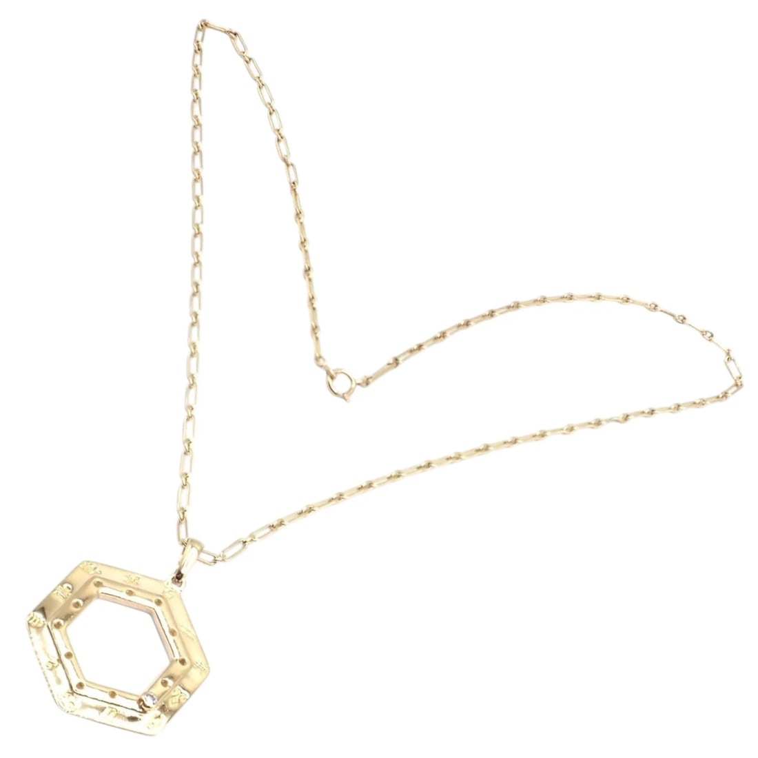 Vintage Cartier Zodiac 18k Yellow Gold Diamond Pendant Link Chain Necklace: Crafted in 18k yellow gold, this vintage Cartier Zodiac pendant necklace features a distinctive hexagonal frame engraved with astrological symbols. A single diamond accent adds refined sparkle that