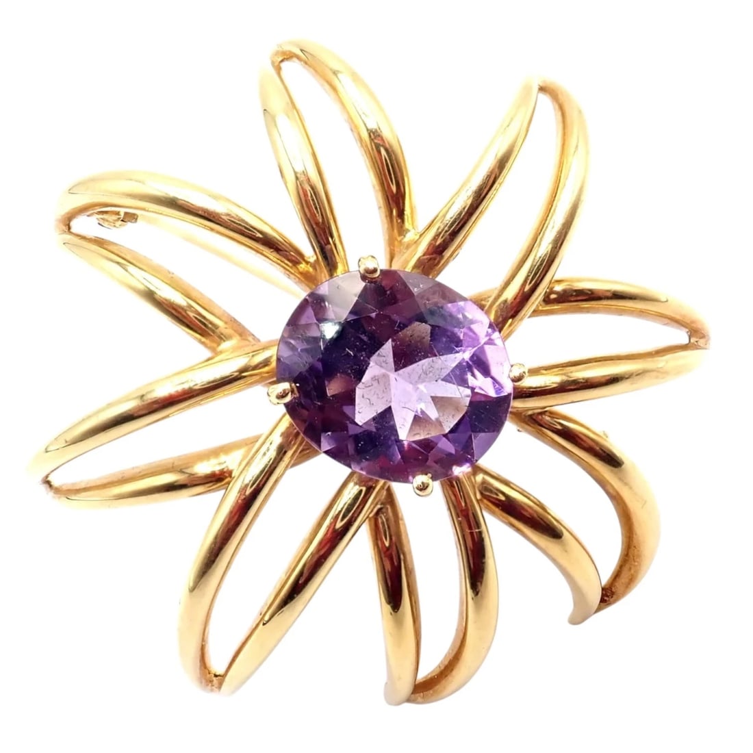 Authentic! Tiffany & Co Fireworks 18k Yellow Gold Amethyst Pin Brooch 1994: This Tiffany & Co. Fireworks brooch is crafted in 18k yellow gold, featuring a vibrant round amethyst framed by sculptural looping rays. Dating to 1994, this collectible design captures the energy and
