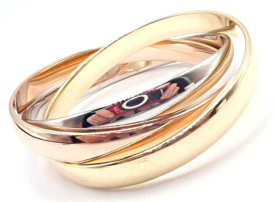 Cartier 18k Tricolor Gold Trinity Large Model Medium Size Bangle Bracelet: Cartier 18k Tricolor Gold Trinity Large Model Medium Size Bangle Bracelet About This Piece: About Cartier: The company has a long and distinguished history of serving royalty, as well as stars and cel