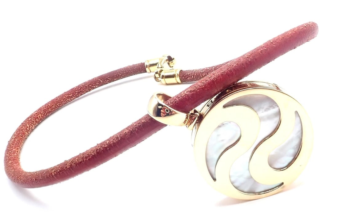 Bvlgari Bulgari Optical Illusion 18K Gold Steel Spinning MOP Pendant Necklace: Bvlgari Bulgari Optical Illusion 18K Gold Steel Spinning MOP Pendant Necklace About This Piece: About BVLGARI: The jewelry created by the Bvlgari - Italian firm, which was founded by the Bvlgari