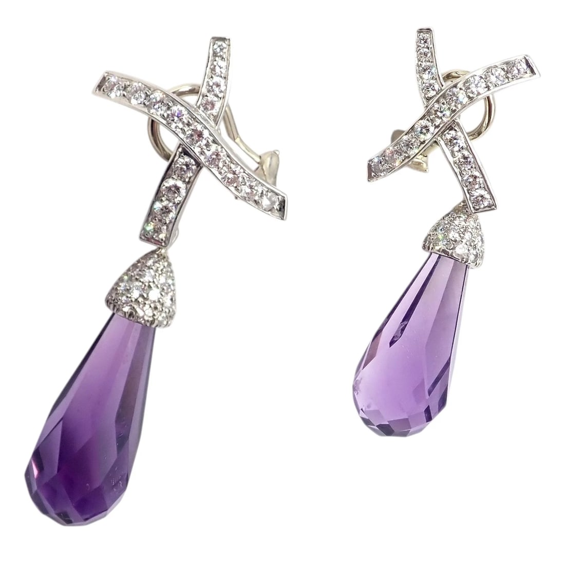 Tiffany & Co Picasso Platinum X Drop Diamond Amethyst Night + Day Earrings 1985: Crafted in platinum, these Tiffany & Co. Paloma Picasso X drop earrings feature pavé-set diamond X motifs suspending faceted amethyst briolettes. The graceful drops showcase rich purple hues and 