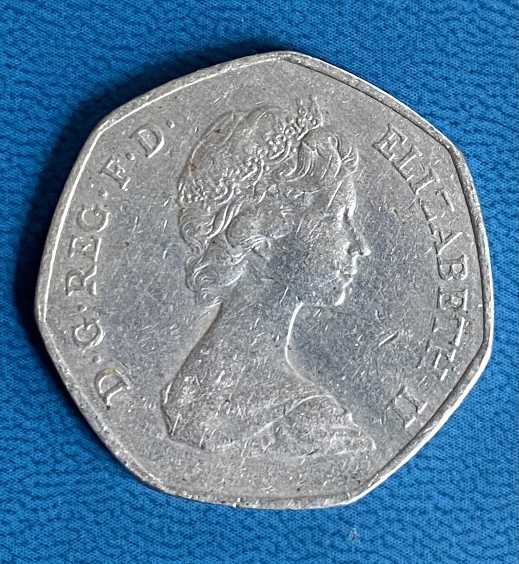 United Kingdom Coin 50 Pence | Elizabeth II 2nd portrait | Entry into EEC | 1973: This United Kingdom 50 Pence coin features the second portrait of Queen Elizabeth II and commemorates the country's entry into the European Economic Community in 1973. The equilateral curve heptagon-s