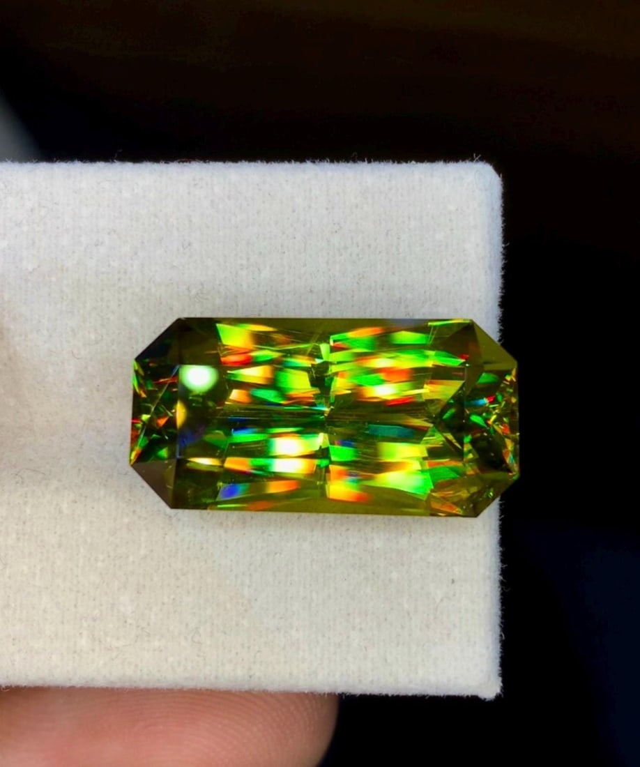 Natural Madagascar Sphene (Titanite) 17.00 Carat - Precision Cut Rainbow Fire Loose Gemstone: Bring extraordinary brilliance to your gemstone collection with this Natural Madagascar Sphene (Titanite) weighing 17.00 carats. Expertly precision cut into a striking rectangular fancy cut, this