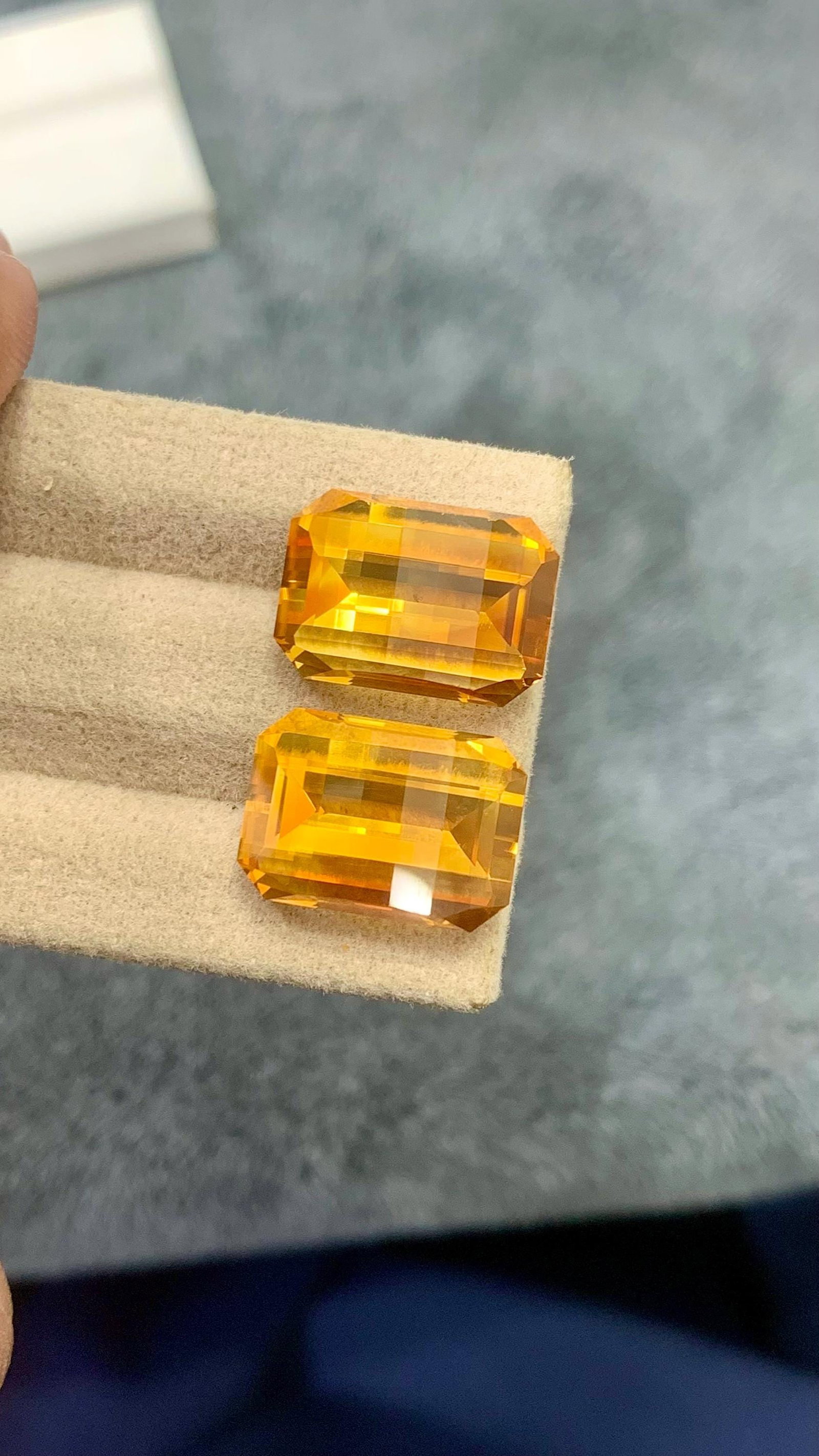 Fancy Emerald Cut aturap Citrine Golden Yellow Pair Gemstone For Earrings - 18.80 carat: This pair of fancy cut citrines is a rare find, boasting a uniform bright orange color that's sure to captivate. The gemstones' matching tone and cut create a sense of harmony, making them perfect for