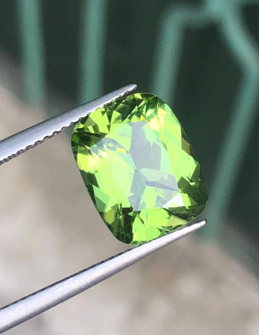 5.985 Carat Sapat Mine Natural Peridot Gemstone For Jewelry: Gemology: * Weight : 5.985 carat * Dimension : 12.4*9.9*6.3 mm * Color : Green * Clarity : Loupe Clean * Shape : Long Cushion * Hardness : 6.5 - 7 * Mineral Class : Olivine * Mine: Sapat * Origin :
