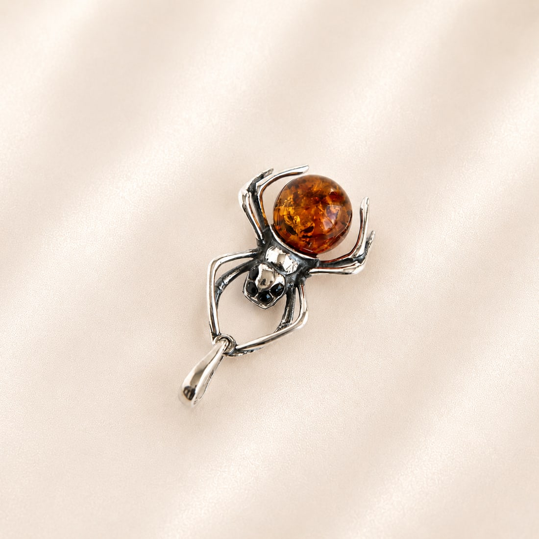 Amber Spider Pendant in Sterling Silver: Title:Amber Spider Pendant in Sterling Silver Description:This amber spider pendant features cognac Baltic amber set in sterling silver. The round amber cabochon has warm cognac, honey, and golden