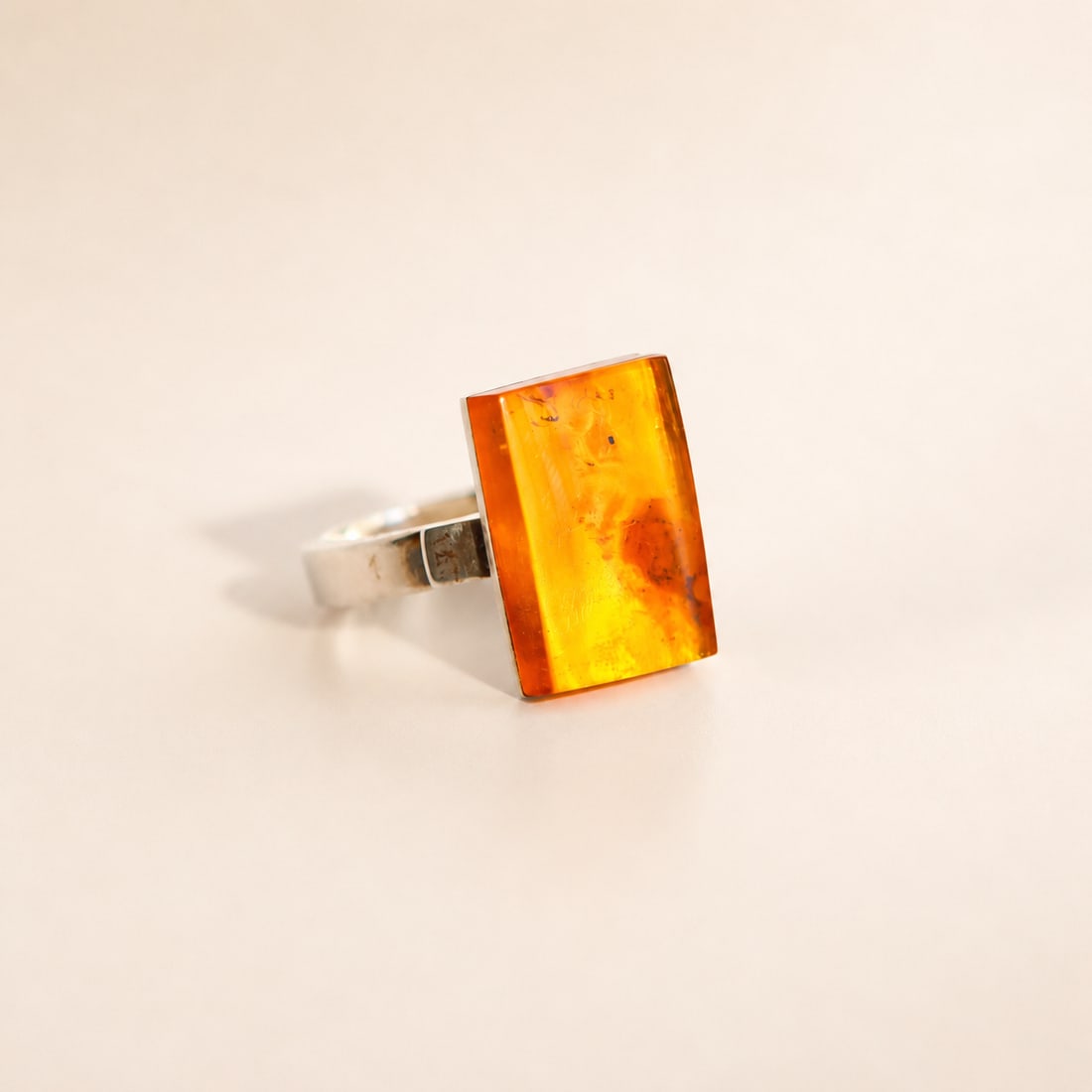Baltic Amber Ring in Sterling Silver- by Mariusz Gliwi?ski: Title:Baltic Amber Ring in Sterling Silver- by Mariusz Gliwi?ski Size:Adjustable Description:This amber ring features genuine Baltic cognac amber set in a contemporary sterling silver design by Polish