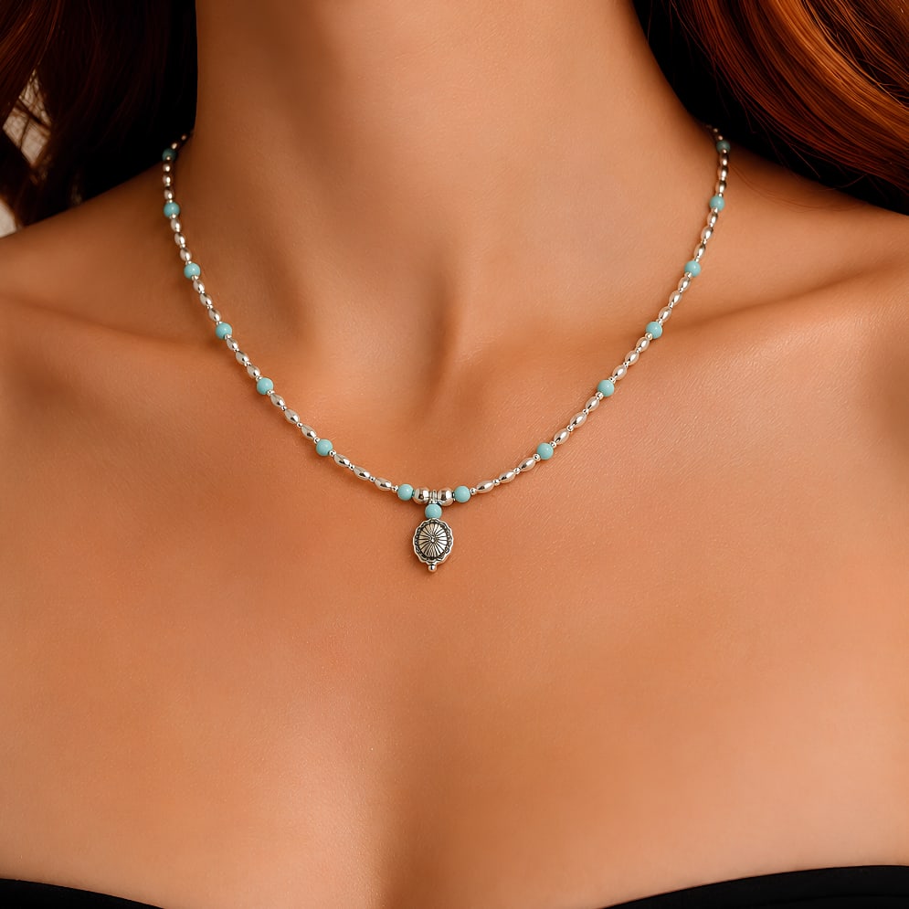 Mesa Concho Necklace: Title:Mesa Concho Necklace Description:The Mesa Concho Necklace is a delicate silver and turquoise necklace designed with small howlite turquoise beads spaced along a silver-tone beaded strand. The