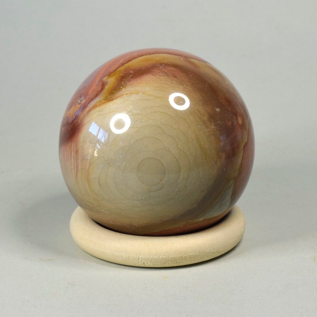 6.1 cm Polished Polychrome Jasper sphere: Title: 6.1 cm Polished Polychrome Jasper sphere Origin: Madagascar Size: 6.1 cm diameter Description: Species: Polychrome Jasper Locality: Madagascar Diameter: 6.1 cm Weight: 0.29 kg Fine polished oce