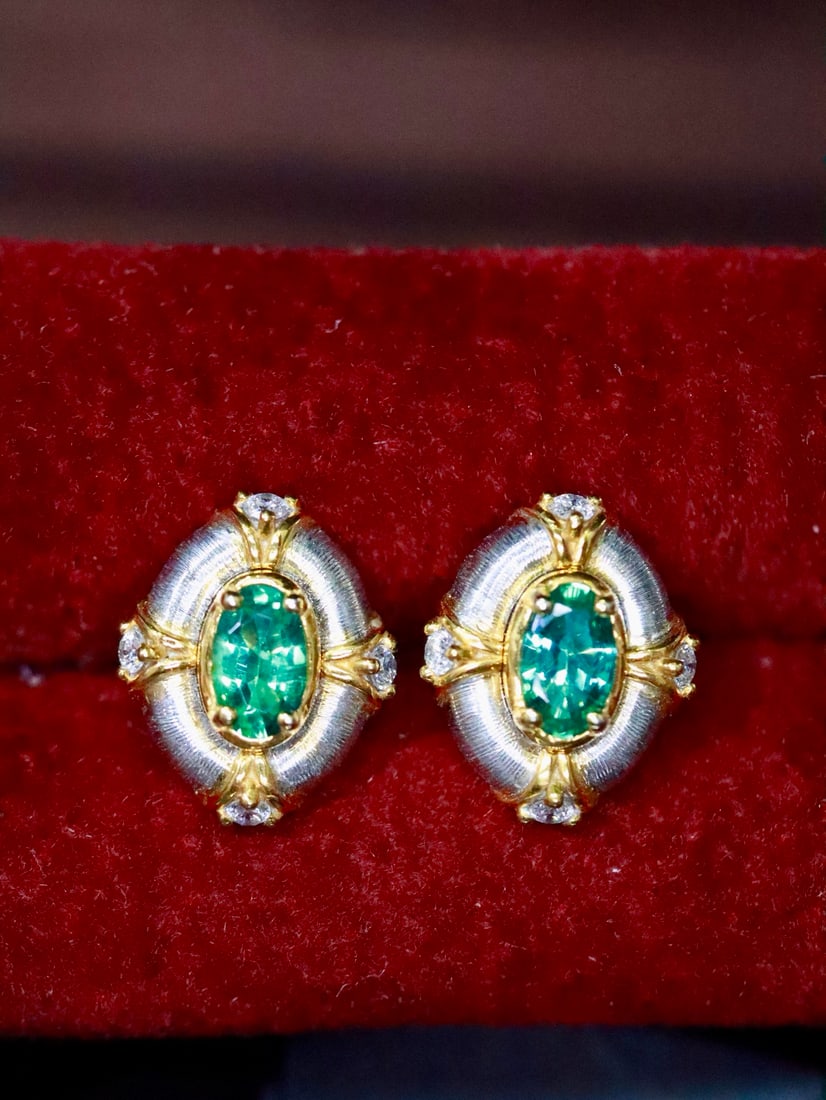 Platinum Natural Emerald Earrings: Title: Platinum Natural Emerald Earrings Description: These earrings are inspired by a vintage style, showcasing a design as smooth as satin. The exquisite craftsmanship gives it a soft texture, with