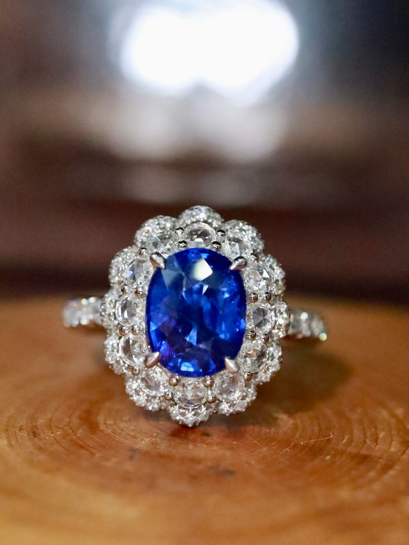 Platinum Natural Sapphire Ring: Title: Platinum Natural Sapphire Ring Description: This platinum ring features a sapphire with a rich hue, showcasing impeccable quality. Luxuriously set with high-quality diamonds, it adds a