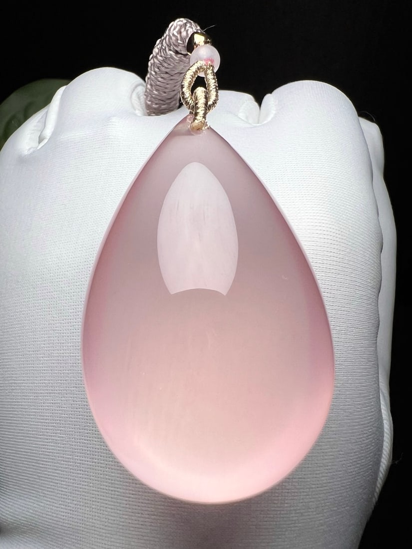 Natural Rose Quartz Pendant: Title: Natural Rose Quartz Pendant Description: This pendant is crafted from natural rose quartz, featuring a translucent crystal with a soft pink hue. Each piece is meticulously hand-polished into a